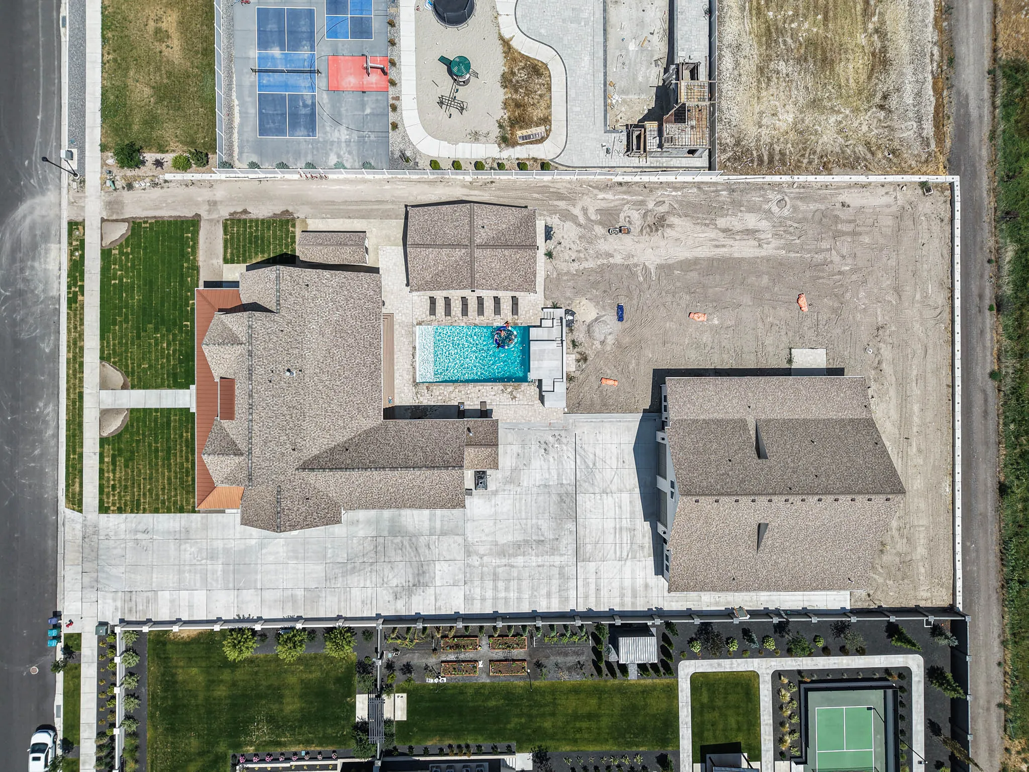 Expansive property featuring a main residence, detached structure, and a large swimming pool