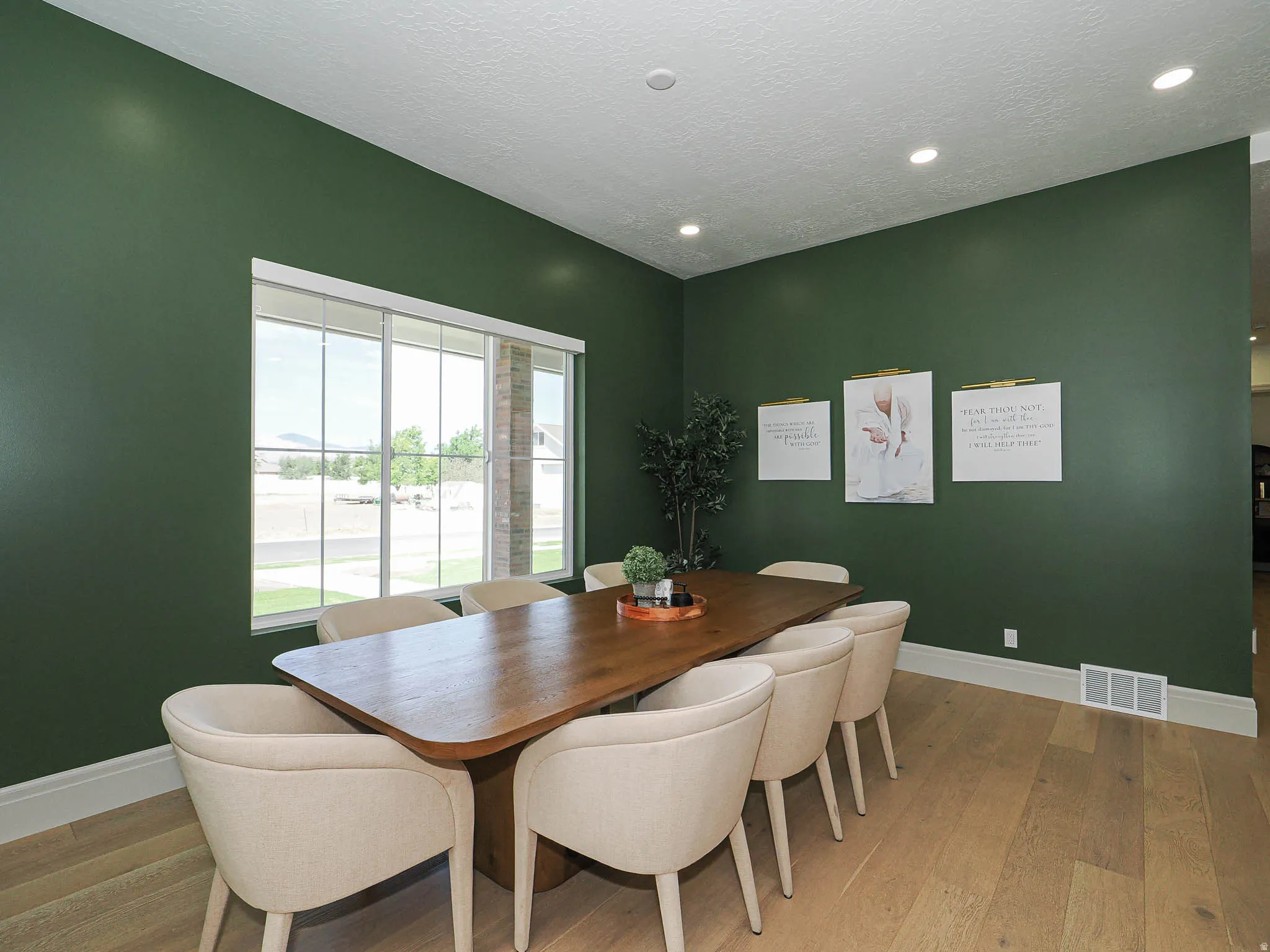 Hardwood-style flooring throughout this space with deep green accent walls