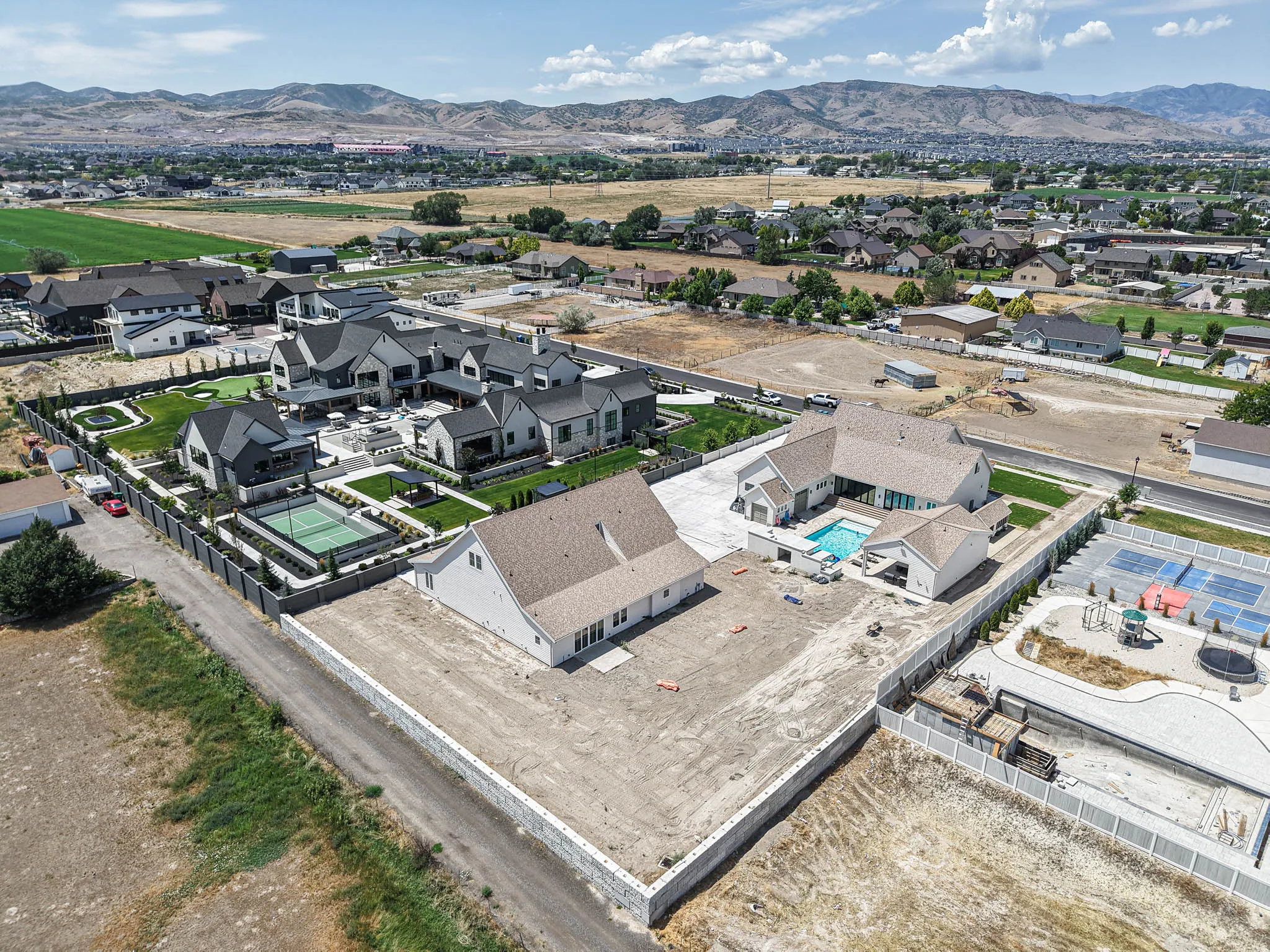 Aerial perspective showcasing multiple properties with extensive outdoor amenities