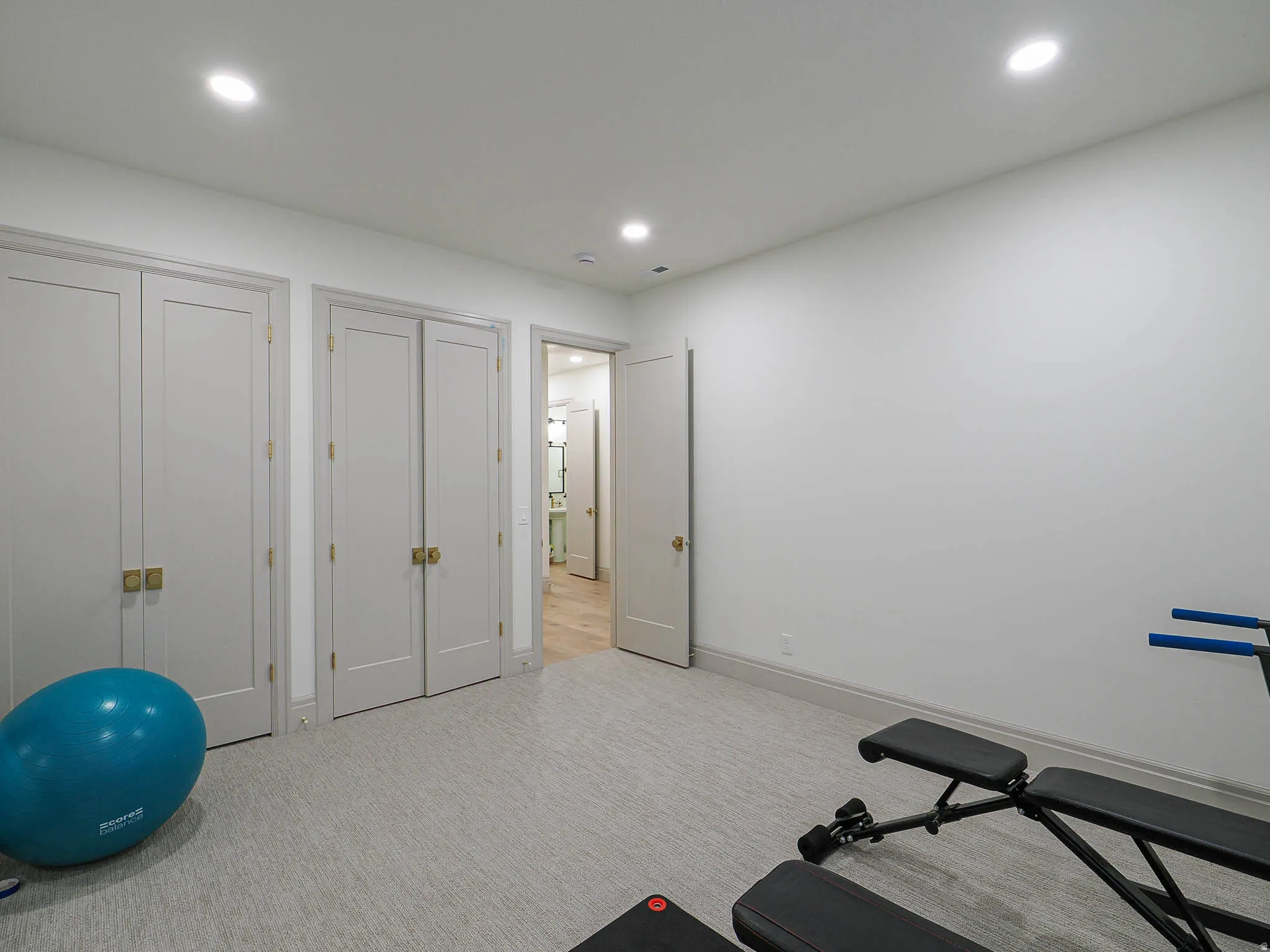 Room featuring recessed lighting, light-toned wall-to-wall carpeting, and baseboard molding
