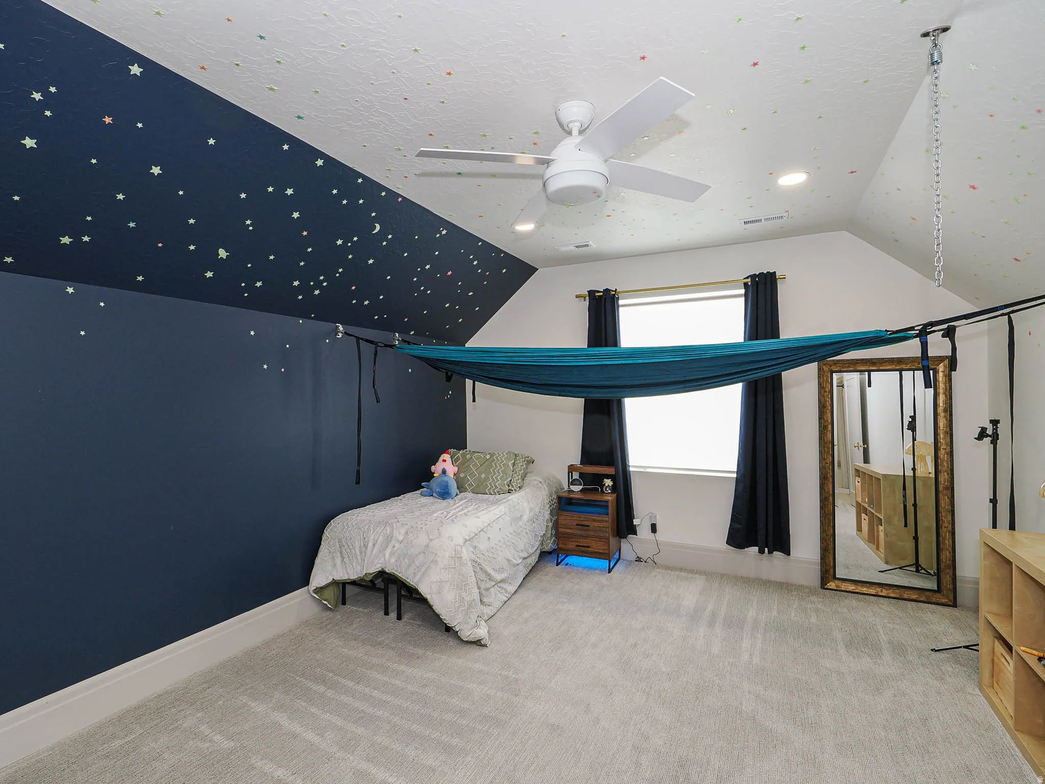 Carpeted room featuring a vaulted ceiling with recessed lighting and a ceiling fan