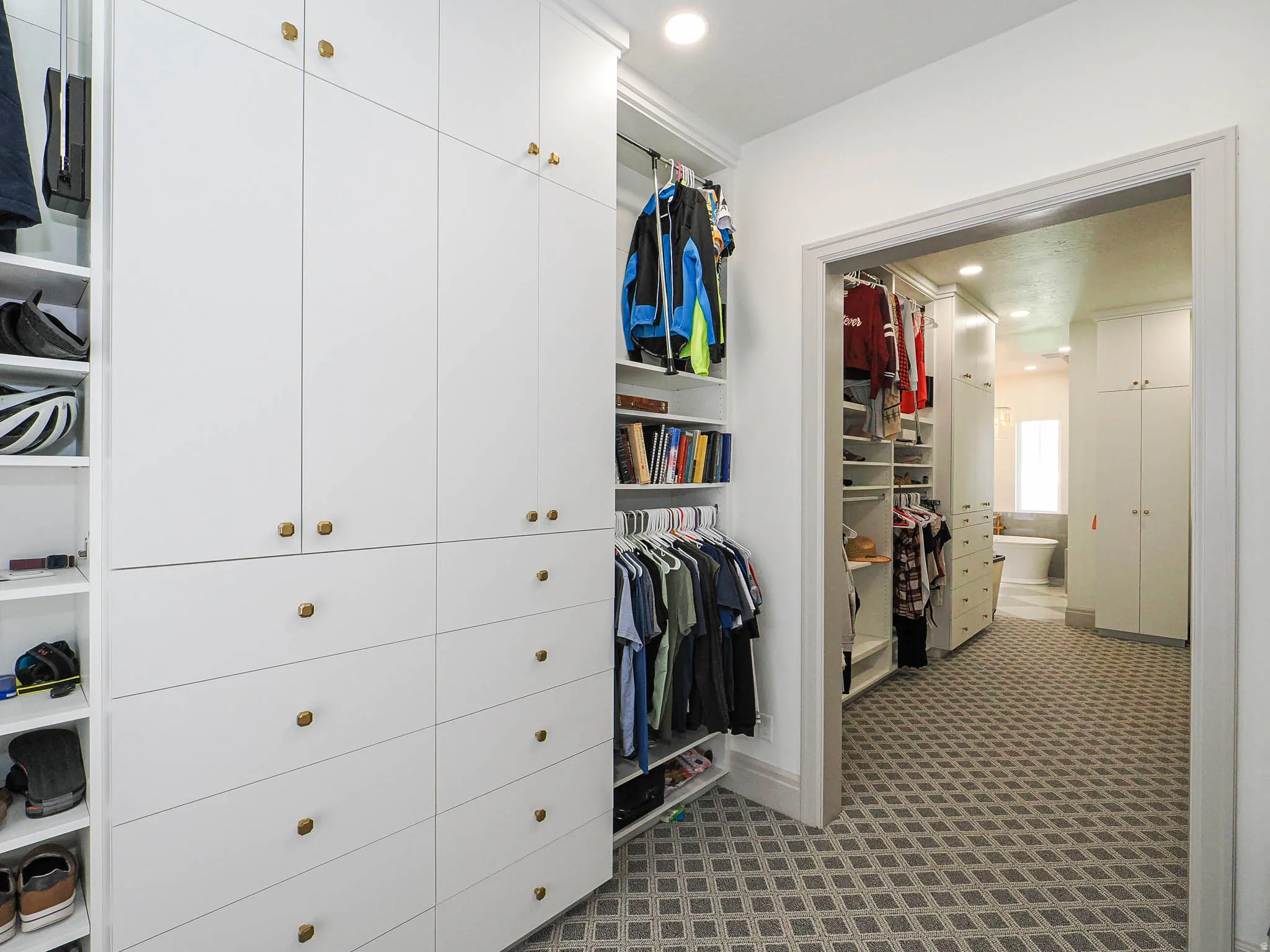 Custom built-in white cabinetry with gold-tone hardware