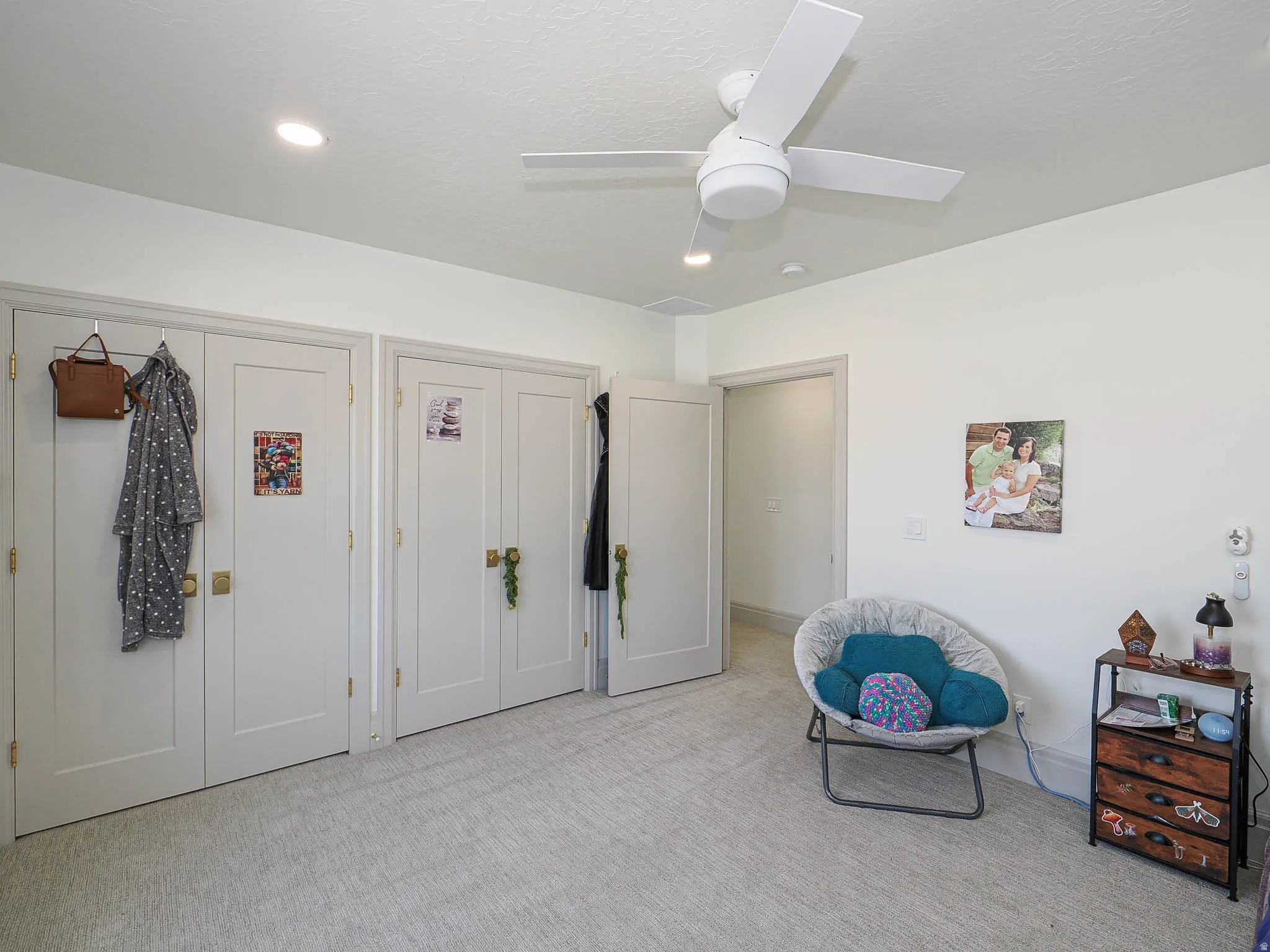 Recessed lighting illuminating a light-toned carpeted floor