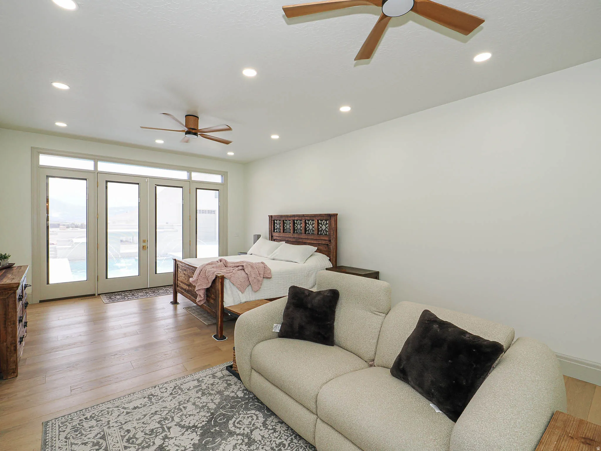 Room featuring wood-finish flooring, recessed lighting, and dual ceiling fans