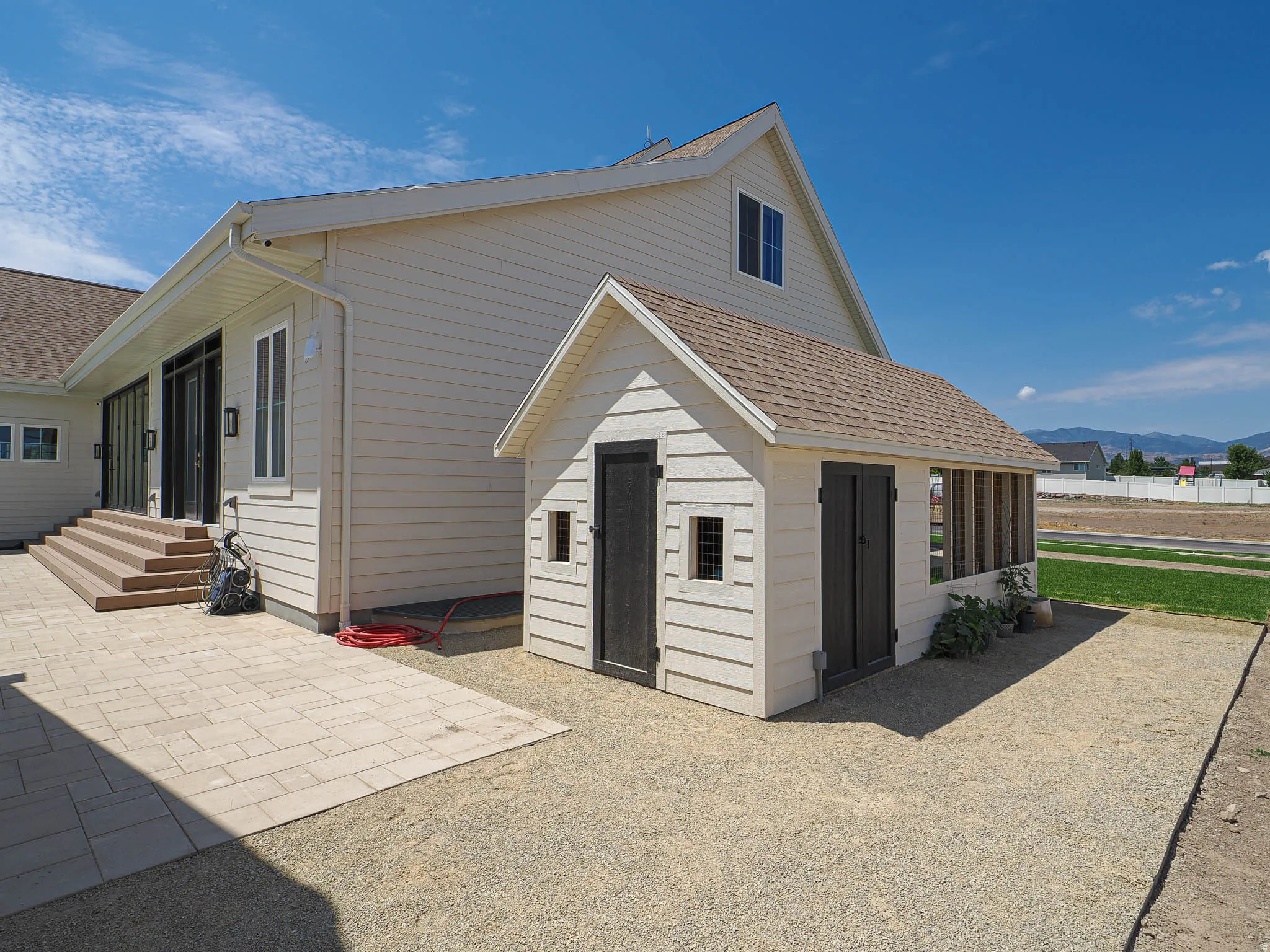 Detached shed with dark doors and siding