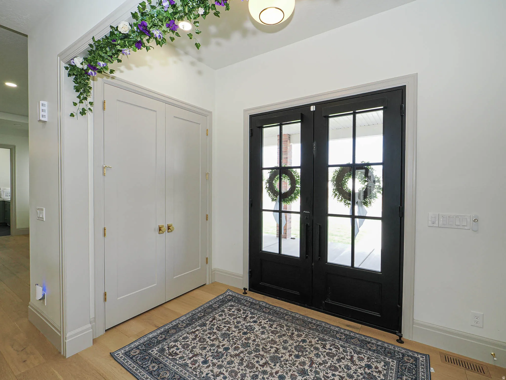 Double black French doors with clear glass panels