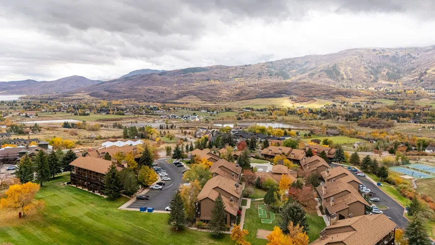 Expansive aerial showcasing a residential community with brown-toned buildings and complementary earth-toned roofs