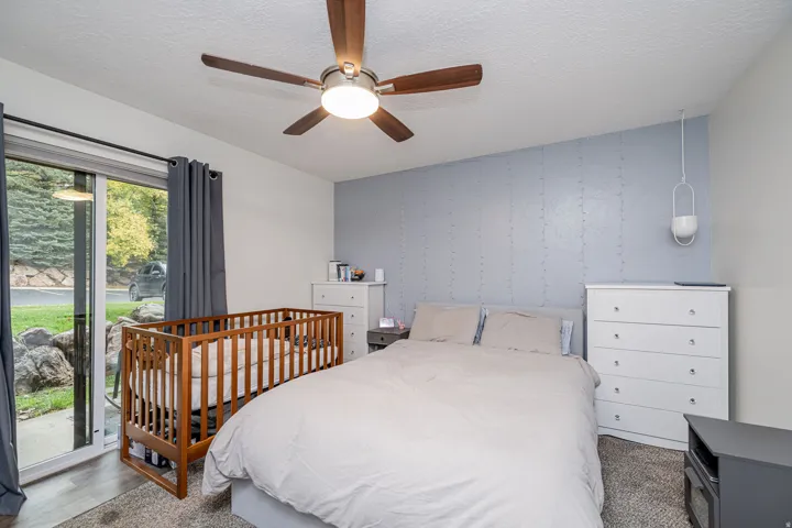 Spacious room featuring wood-finish flooring and a textured accent wall
