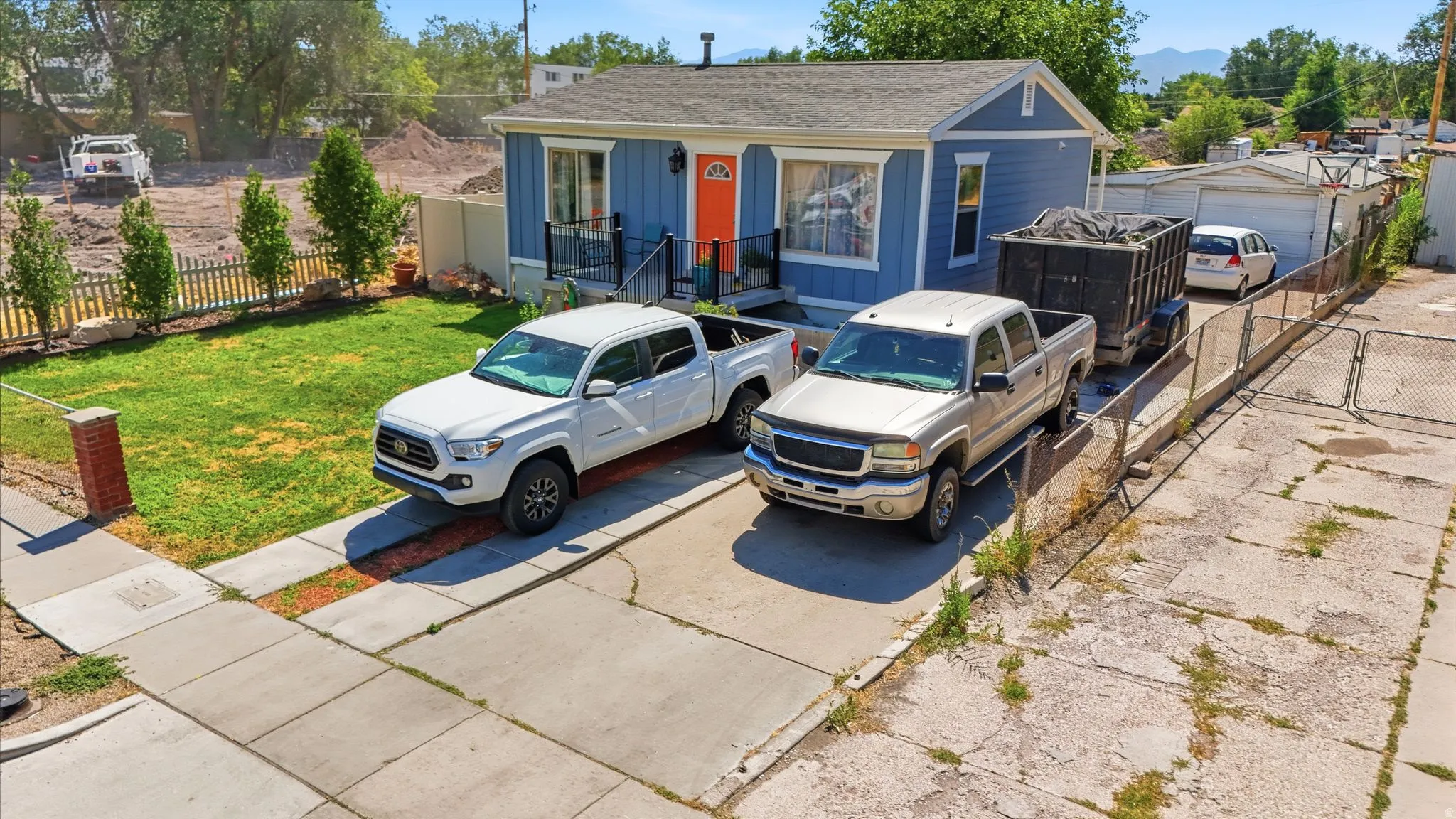 Light blue siding exterior with an orange entry door and white trim