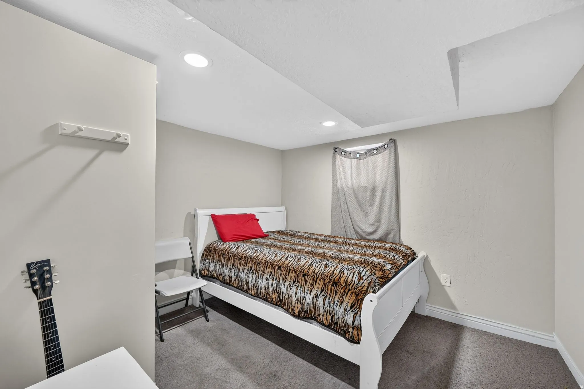 Room featuring recessed lighting, light-colored wall paint, and a window with a curtain rod