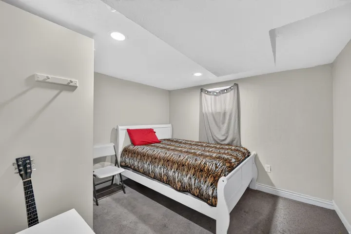 Room featuring recessed lighting, light-colored wall paint, and a window with a curtain rod