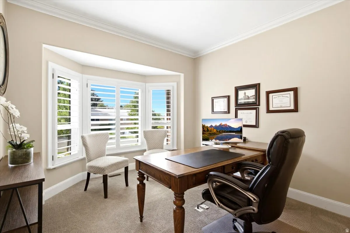 Front office bay window with white plantation shutters