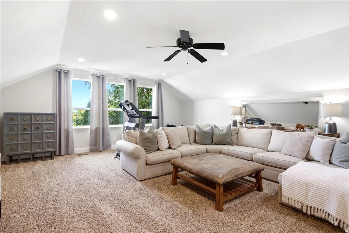 Carpeted bonus room with vaulted ceilings, recessed lighting, and a contemporary ceiling fan