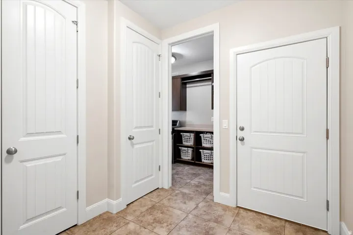 Entryway featuring neutral wall paint and tile flooring