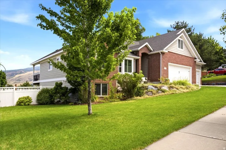 Brick and siding exterior featuring an attached three-plus-car garage