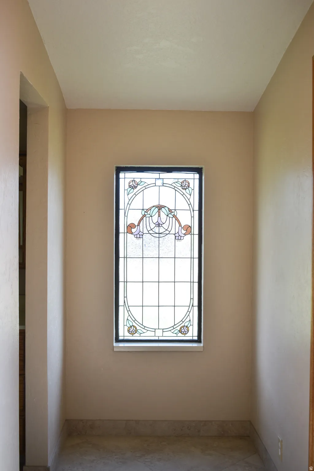 Ornate stained-glass window featuring an abstract floral design