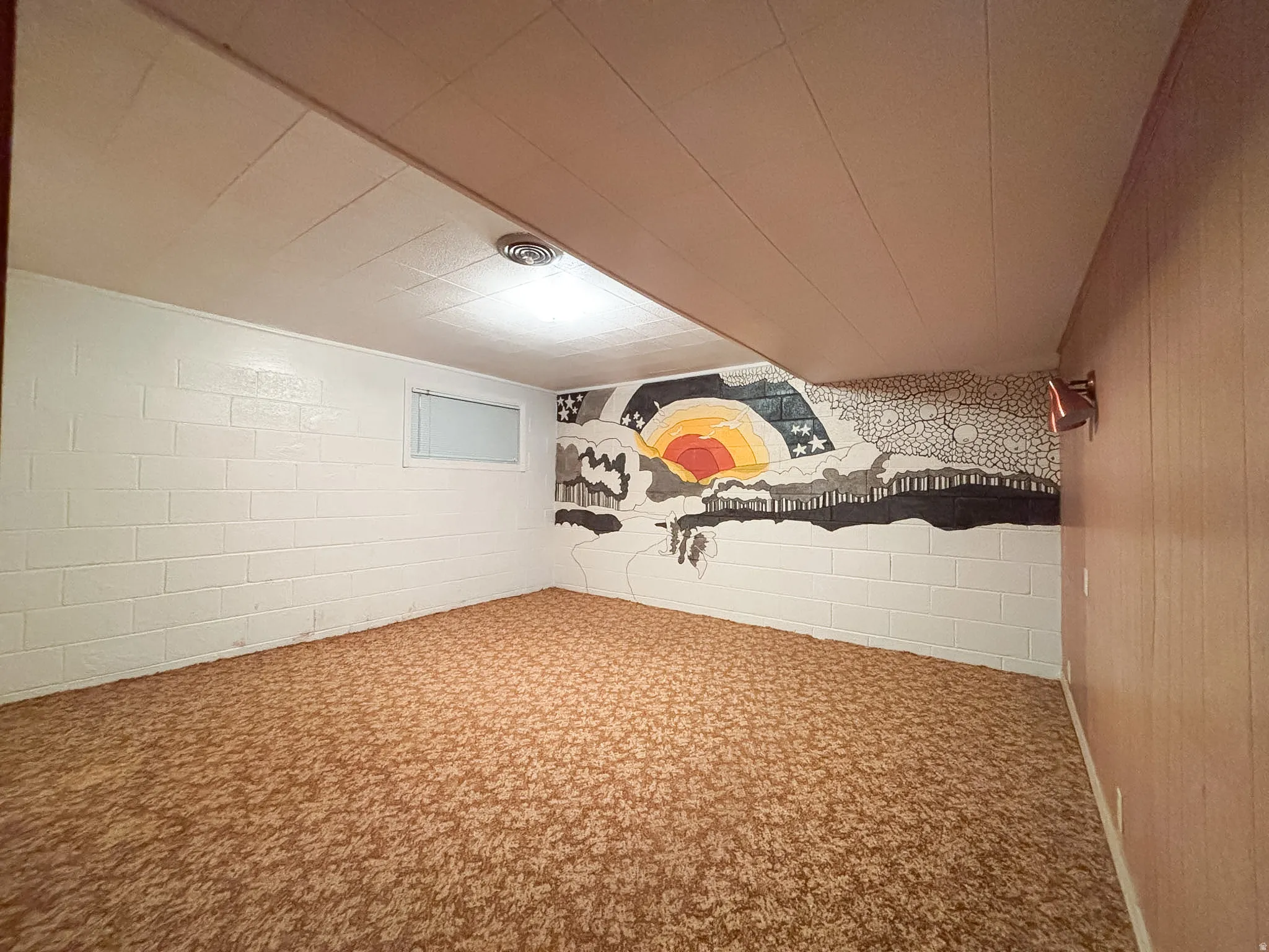 Room featuring patterned carpet flooring and a painted accent wall