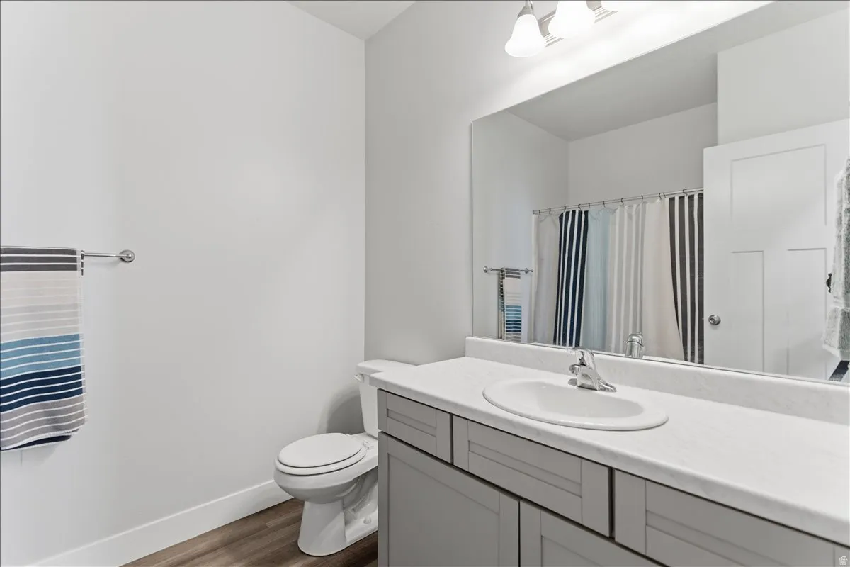 Bathroom vanity with a single basin sink, chrome faucet, and gray shaker-style cabinetry