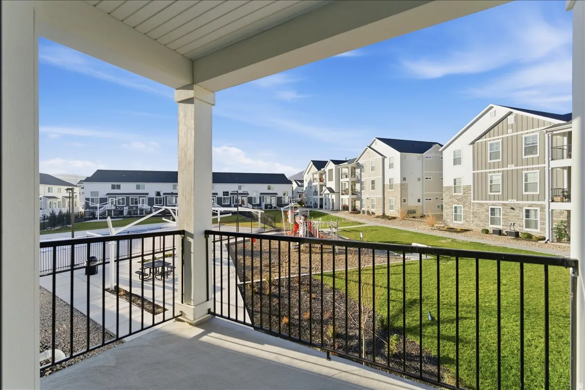 Private balcony with a concrete floor and black metal railing