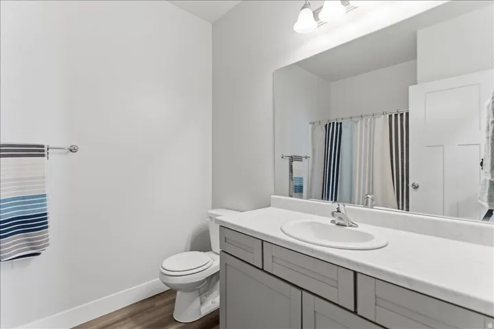Bathroom vanity with a single basin sink, chrome faucet, and gray shaker-style cabinetry