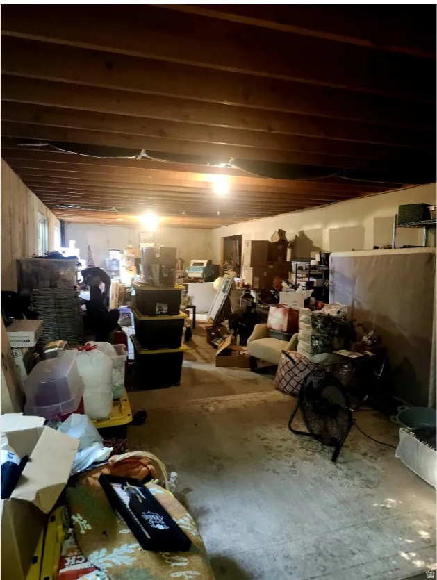 unfinished family room in basement with lots of storage