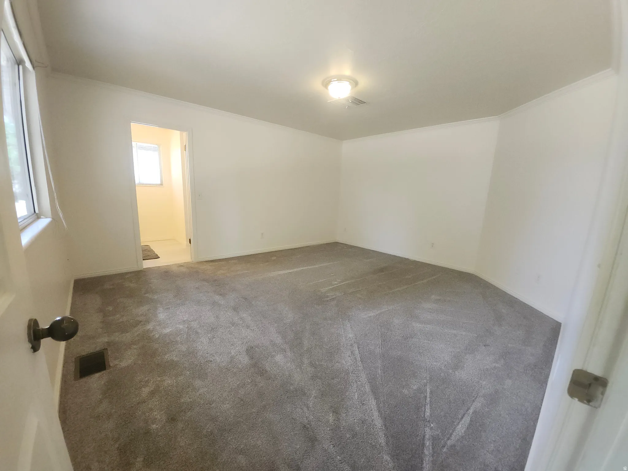 Primary bedroom with on suite bath and huge walk in closet and large shower. Spacious room featuring polished concrete flooring, fresh white walls, and recessed ceiling lighting