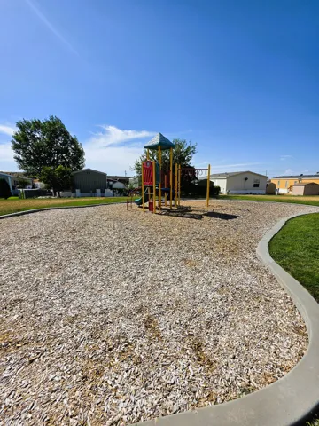 Community playground featuring a multi-level structure with slides and swings