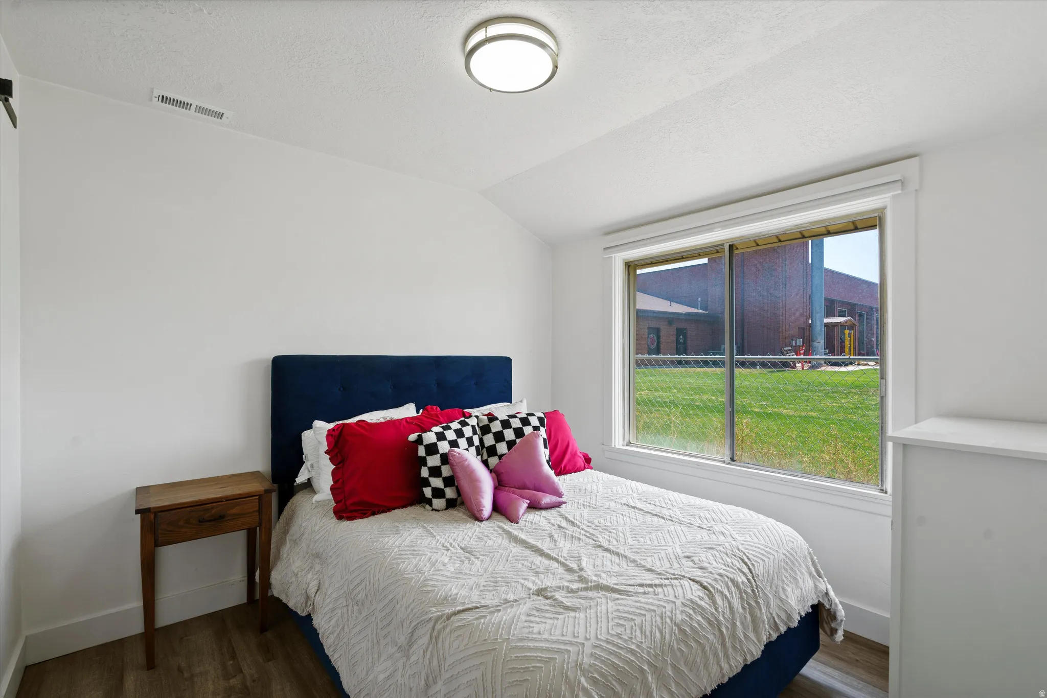 Bright room with wood-finish flooring and white walls