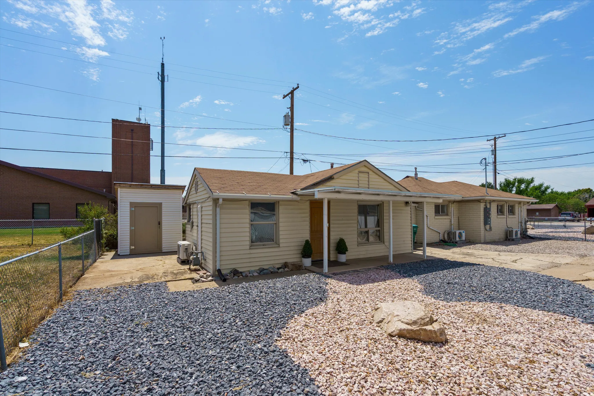 Exterior featuring light-colored siding and a covered front entry