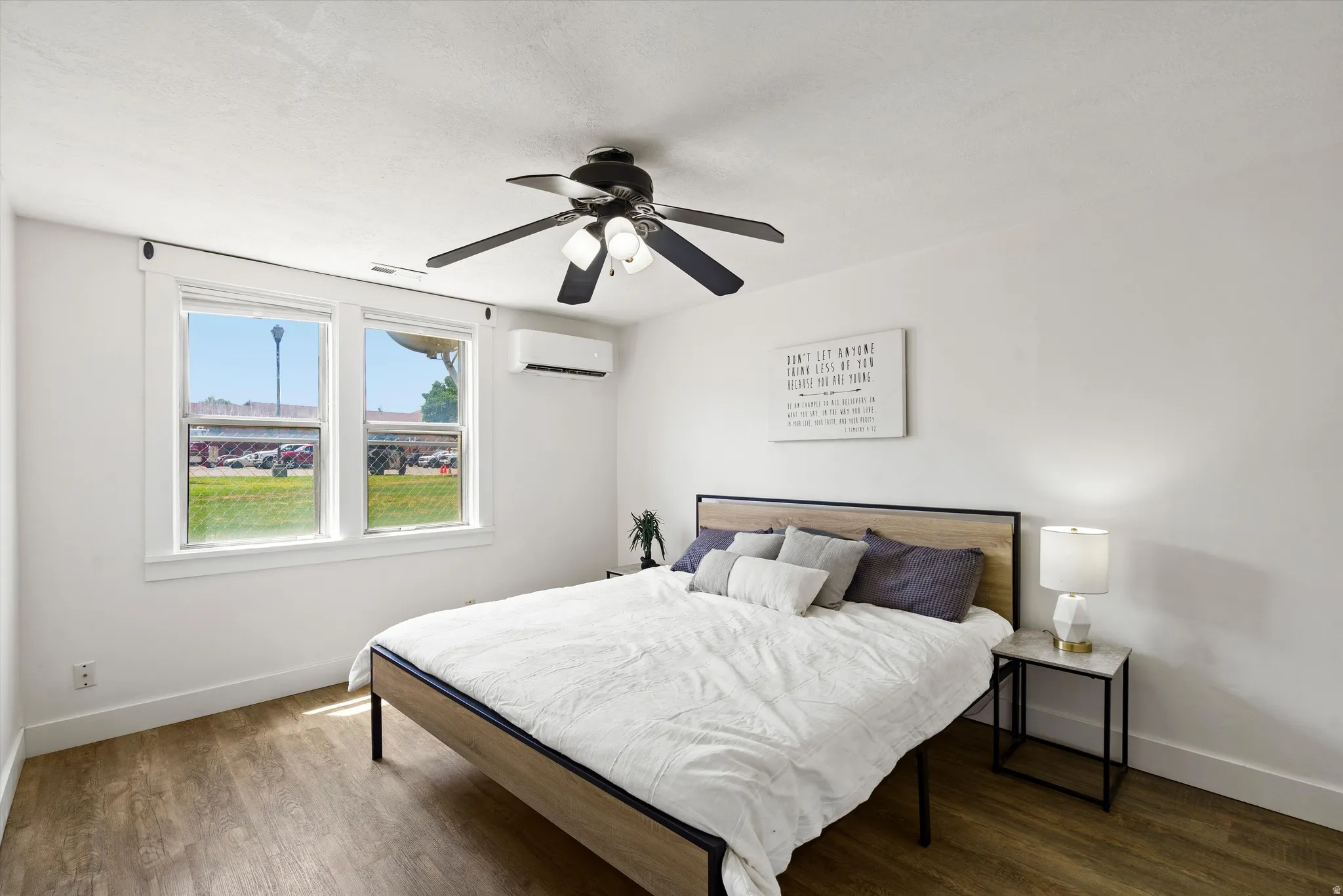Room featuring wood-finish flooring and a white wall finish