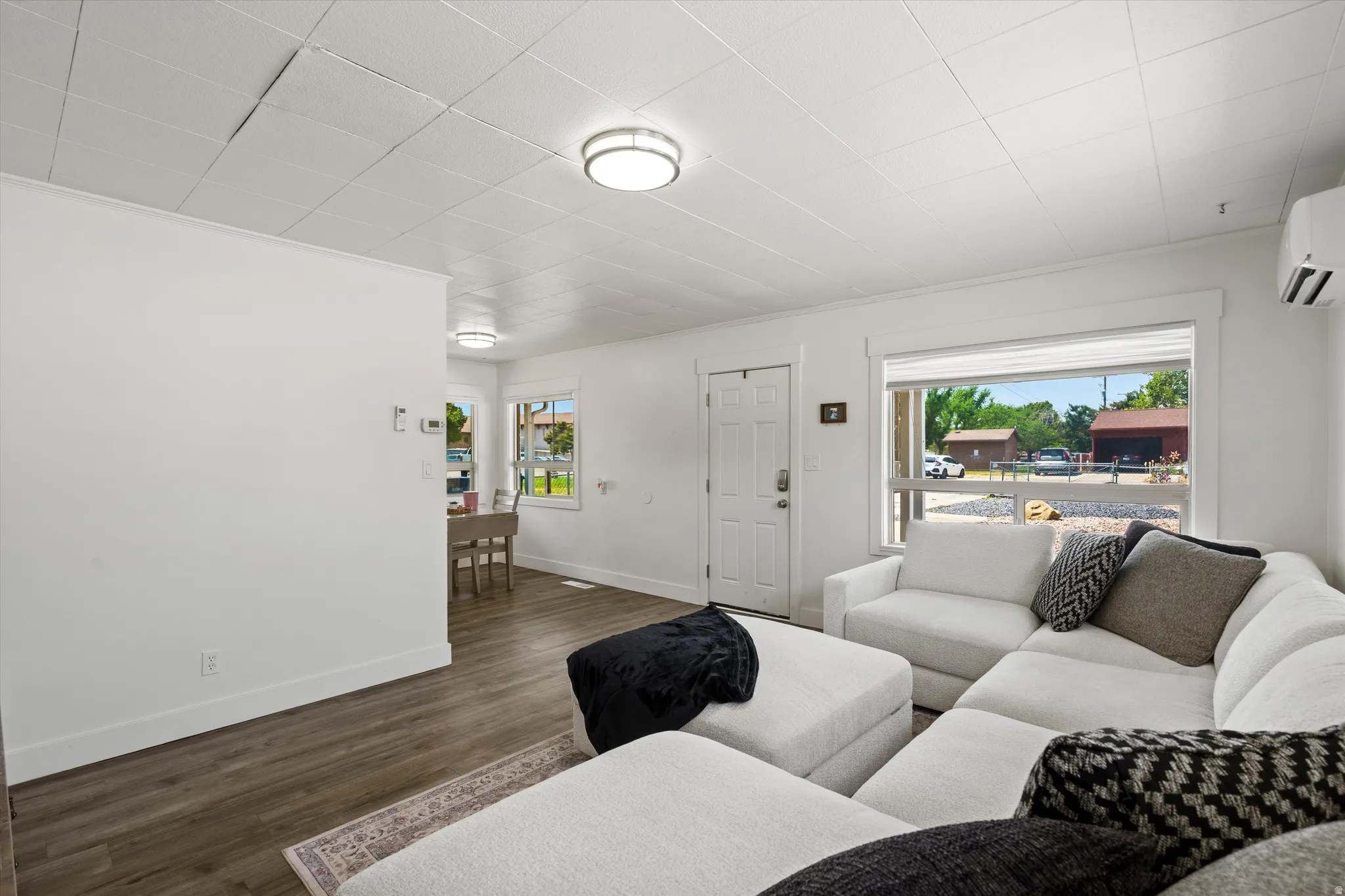 Open concept living area with wood-finish flooring