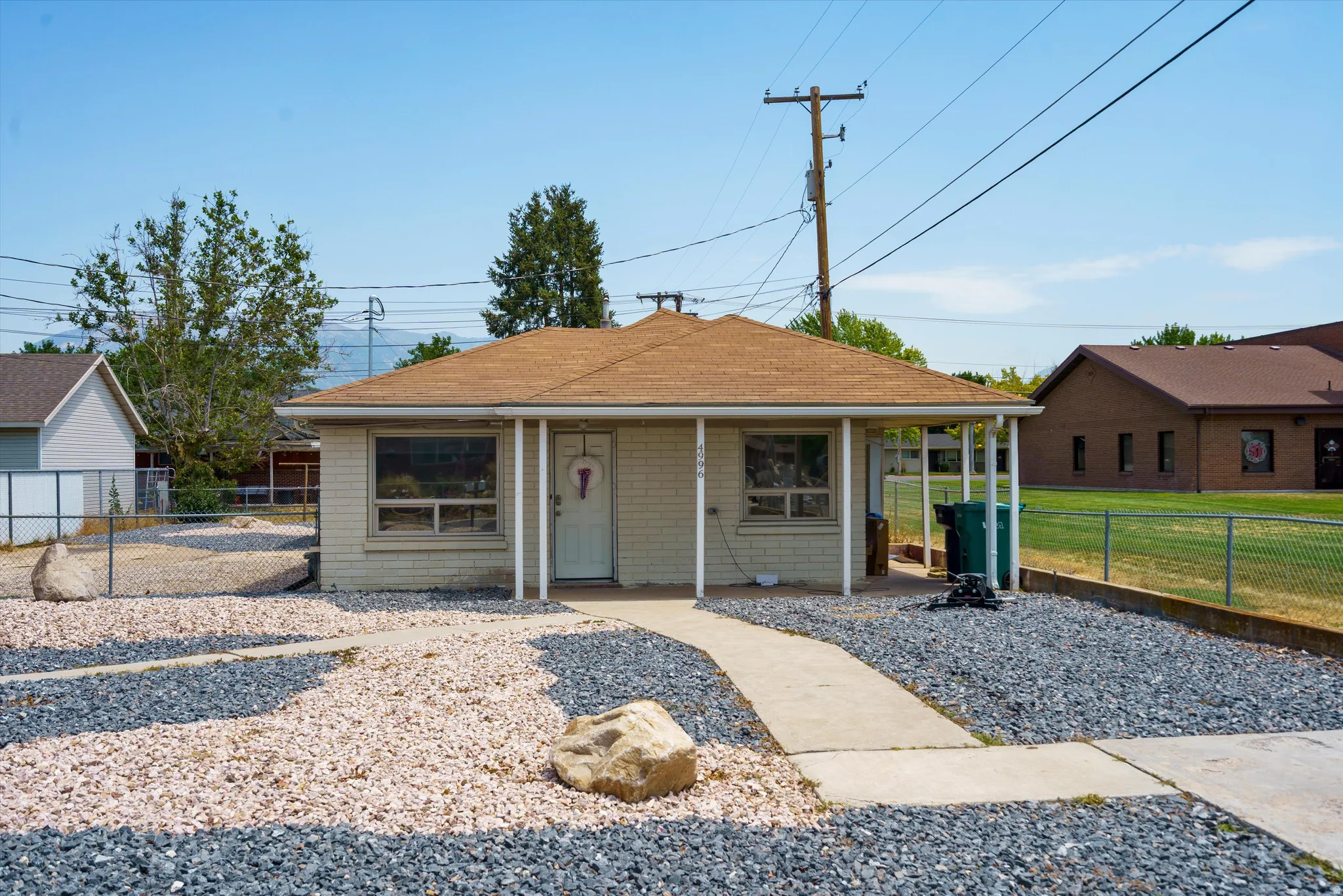 Single-story structure with a covered front porch and a light-colored exterior finish