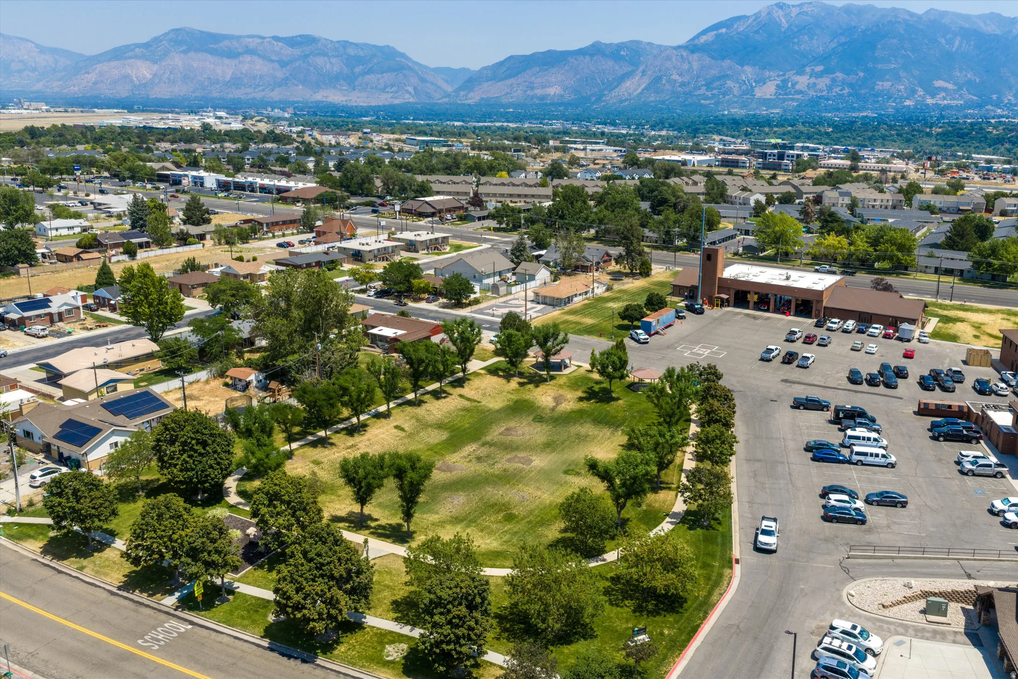 Aerial perspective showcasing a residential neighborhood with distant mountains