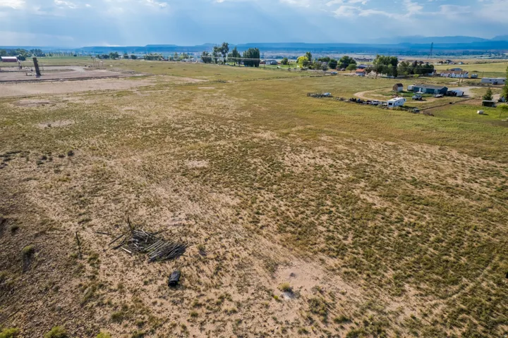 Expansive undeveloped land featuring natural terrain and distant mountainous backdrop