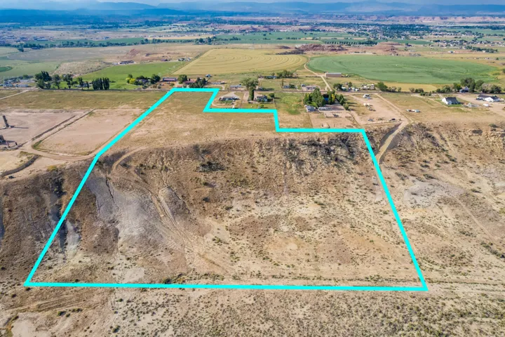 Expansive land parcel featuring diverse topography, including level ground and sloped terrain