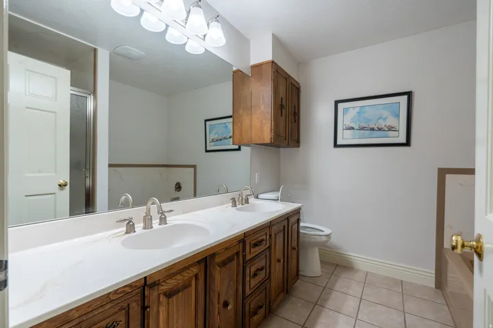 Double vanity with integrated sinks, brushed nickel faucets, and a white countertop