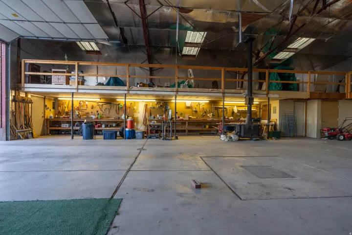 Spacious warehouse interior featuring a concrete floor and exposed beam ceiling