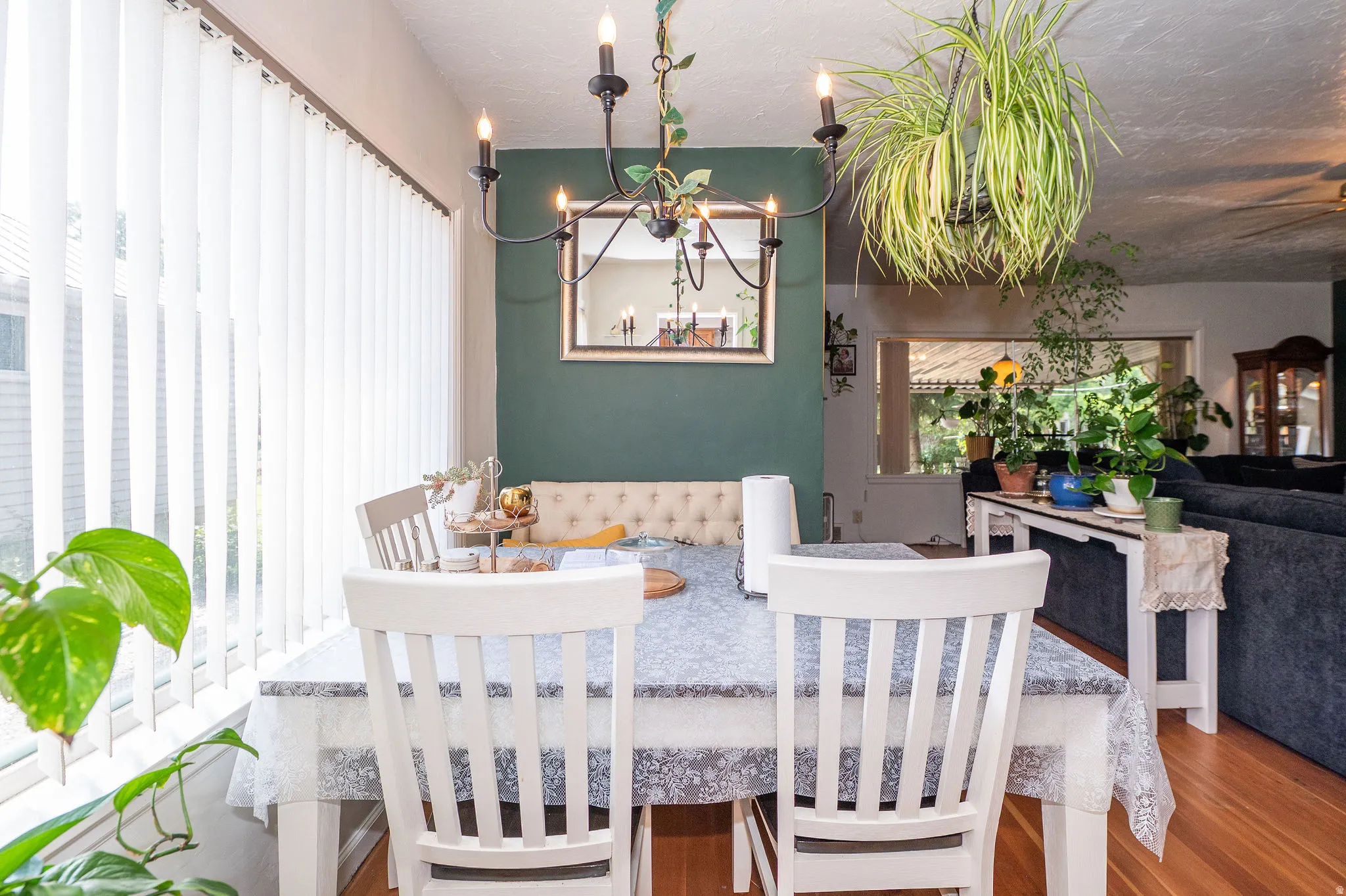 Dining area featuring wood-finish flooring, a contemporary chandelier, and a built-in bench seat