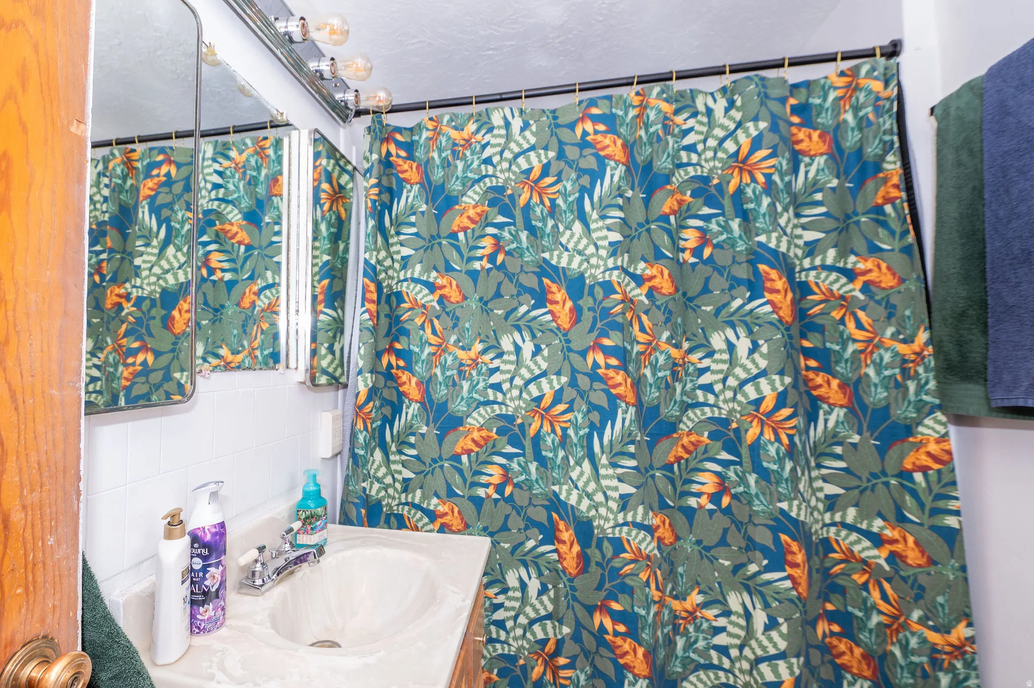 Bathroom featuring a built-in vanity with an integrated sink and chrome faucet