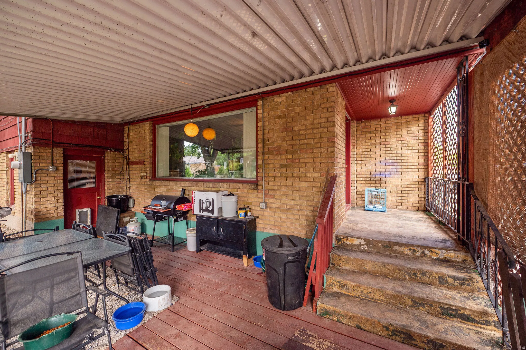 Covered outdoor patio area featuring a corrugated ceiling