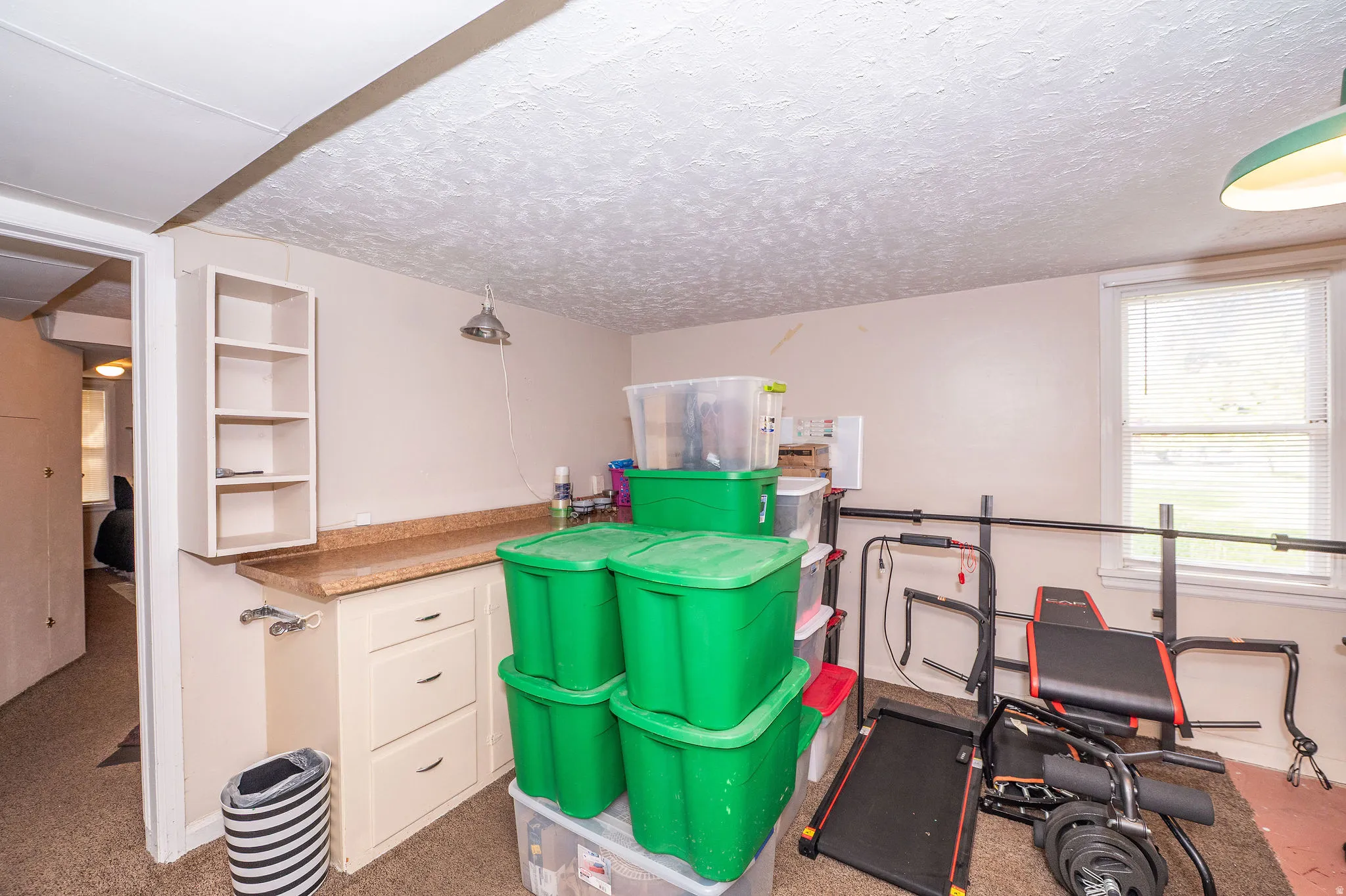 Utility area featuring a built-in countertop with cabinetry, open shelving, a window with blinds, and recessed lighting
