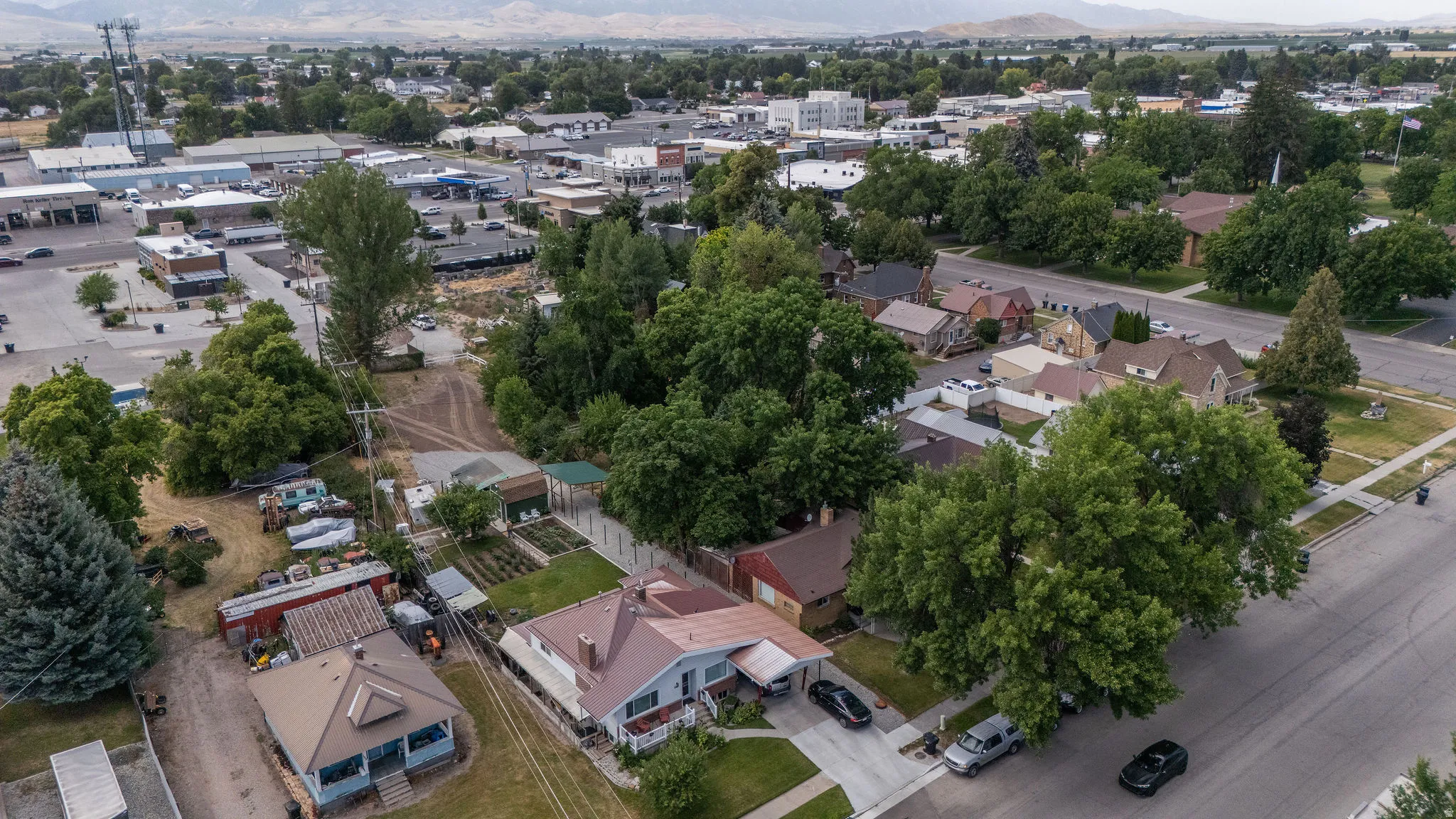 Aerial depiction of a residential area with varied housing styles and mature tree coverage