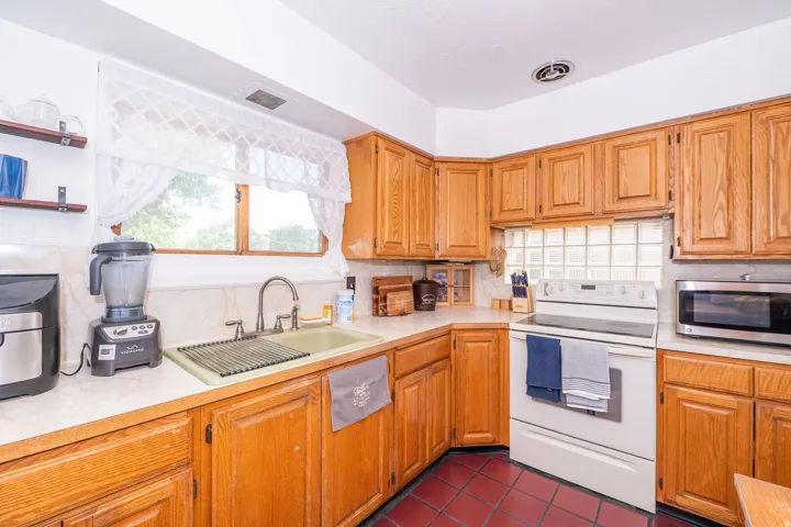 Kitchen featuring wood cabinetry, solid surface countertops, and a full-size range