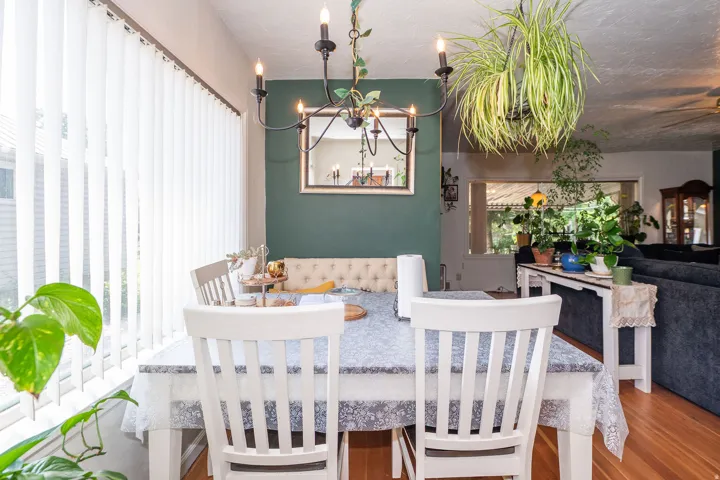 Dining area featuring wood-finish flooring, a contemporary chandelier, and a built-in bench seat