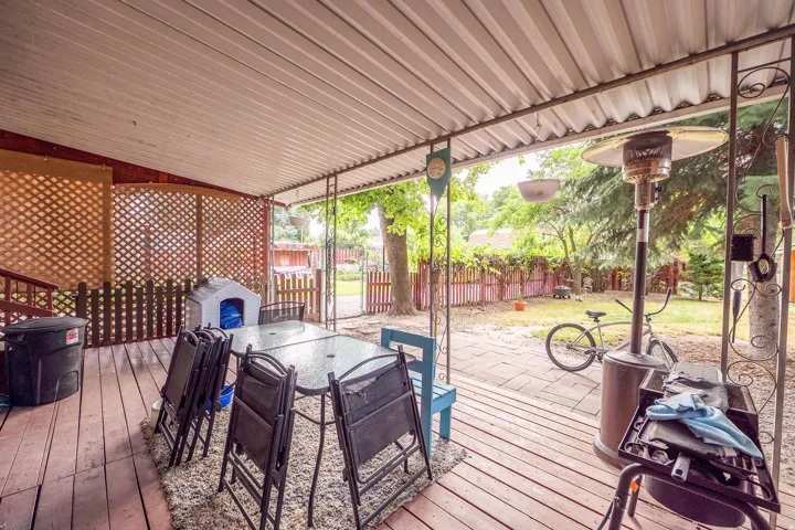Expansive covered patio featuring wood decking and a slatted ceiling