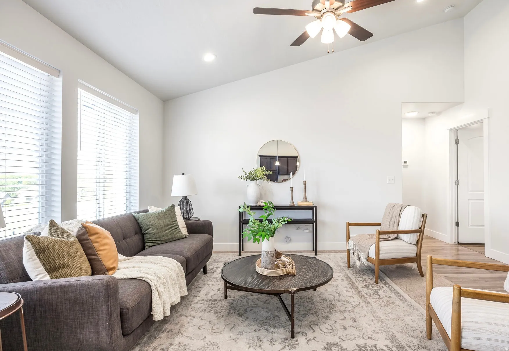 Vaulted ceilings featuring a ceiling fan, recessed lighting, and wood-finish flooring