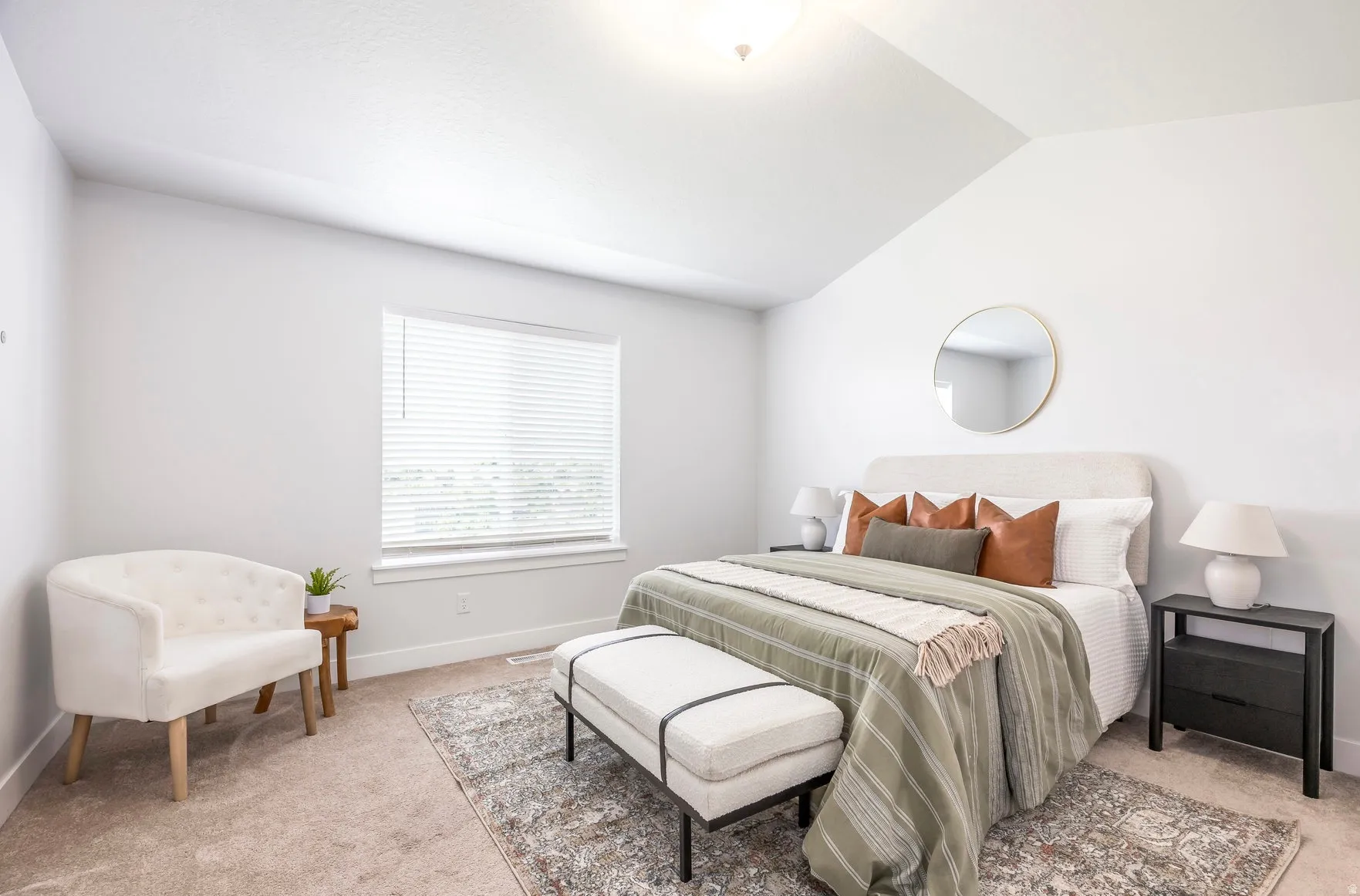 Carpeted room featuring a vaulted ceiling and a rectangular window with blinds