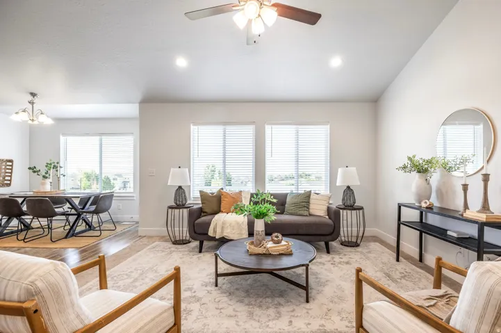 Spacious living area featuring high ceilings, recessed lighting, and a ceiling fan