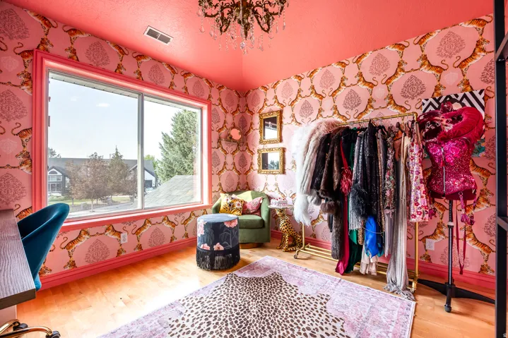 Spacious room featuring light wood-finish flooring and a large window