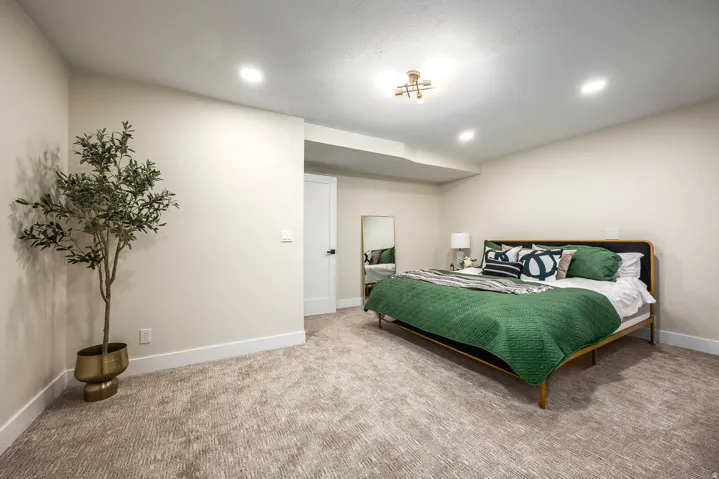 Carpeted flooring throughout, featuring recessed lighting and a contemporary ceiling fixture